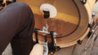 man playing bass drum, pressing foot on pedal sitting