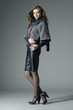 fashion model in fashion dress posing on gray background