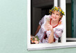 Portrait Happy Ukrainian woman in the window