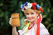Portrait Happy Ukrainian woman with a wooden mug