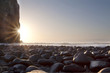 Sunrise landscape with rocks cliffs and ocean and blue sky
