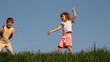 Boy shakes rattle in form of hands, and his sister dances