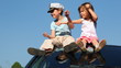 Video: children sit on roof of car and twist imaginary driving wheel children sit on roof of car and twist imaginary driving wheel
