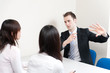 a young businessman talking to women