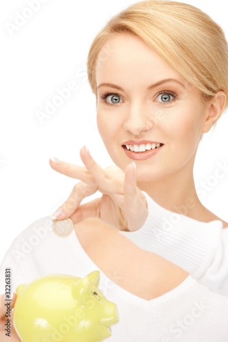 Photo: lovely woman with piggy bank and money lovely woman with piggy bank and money