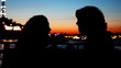 silhouettes girls sitting and talking on deck of ship sailing