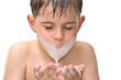 A boy swims in the bathtub