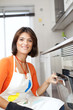 Woman opening the kitchen oven