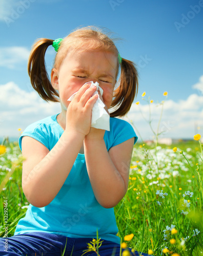 Photo: Little girl is blowing her nose Little girl is blowing her nose