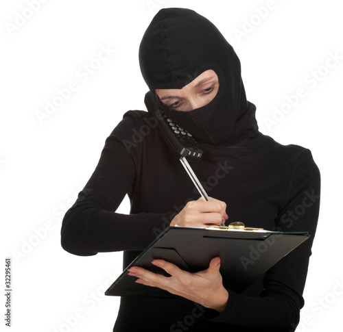 Photo: calling young female thief writing on black clipboard calling young female thief writing on black clipboard