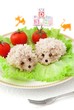 Children's food - two rice hedgehogs with tomatoes