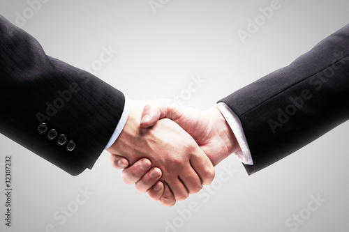 Photo: Handshake - Hand holding on white background Handshake - Hand holding on white background