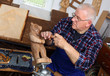 Photo: Woodcarver work in his workshop Woodcarver work in his workshop