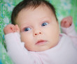 Photo: Beautiful baby girl is lying in a bed. Beautiful baby girl is lying in a bed.