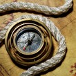 Photo: Compass with rope on the old map Compass with rope on the old map