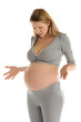 astonished pregnant woman in gray suit