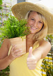 Photo: Junge Frau mit Pflanze "Daumen hoch" Junge Frau mit Pflanze "Daumen hoch"