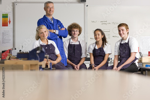 Photo: Smiling teacher with students in vocational school Smiling teacher with students in vocational school