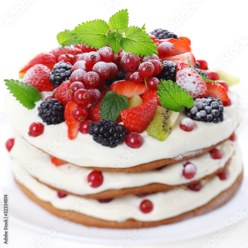 Photo: Cake with fresh fruits isolated on white background, soft focus Cake with fresh fruits isolated on white background, soft focus