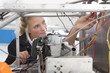 Student constructing electric vehicle prototype in vocational school