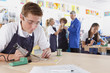 Serious student using soldering iron in vocational school