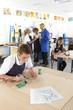 Serious student using soldering iron in vocational school