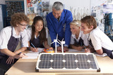 Photo: Teacher talking to students about wind power and solar panels in vocational school Teacher talking to students about wind power and solar panels in vocational school