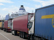 Semi-trucks in line waiting to board ferry boat