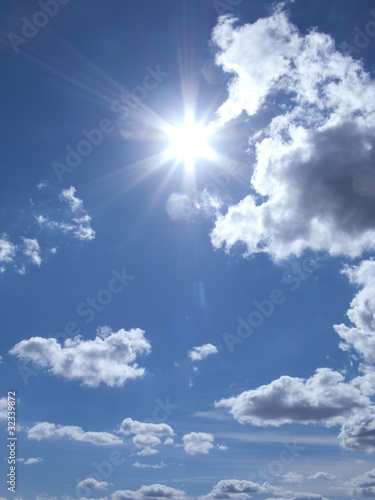 Photo: Sun and clouds floating in blue sky Sun and clouds floating in blue sky