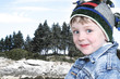Happy Boy in Winter Clothes at Lake Park in Snow