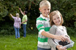 Smiling family gathering berries outdoors together