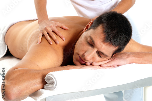 Photo: Man receiving massage relax treatment close-up from female hands Man receiving massage relax treatment close-up from female hands