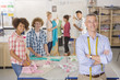 Smiling teacher and students in home economics class