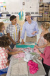 Smiling teacher instructing students in home economics class