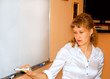 Foto: Teacher writes on board. Teacher writes on board.