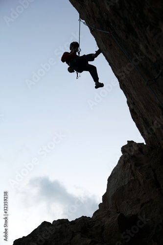Photo: Silhouette of rock climber against sky background Silhouette of rock climber against sky background