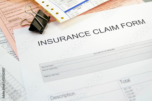 Photo: Health-insurance claim form and medical bills Health-insurance claim form and medical bills