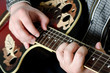 The man plays an electric guitar