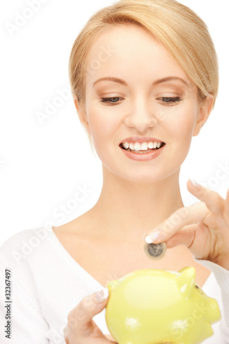 Photo: lovely woman with piggy bank and money lovely woman with piggy bank and money
