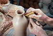 hands of a potter, creating an earthen jar on the circle hands of a potter, creating an earthen jar on the circle