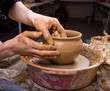 hands of a potter, creating an earthen jar on the circle hands of a potter, creating an earthen jar on the circle