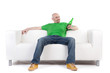 Photo: Man on sofa holding beer Man on sofa holding beer