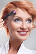 Beautiful smiling woman using dermaroller on face