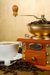 cup full of coffee, beans, pot and grinder