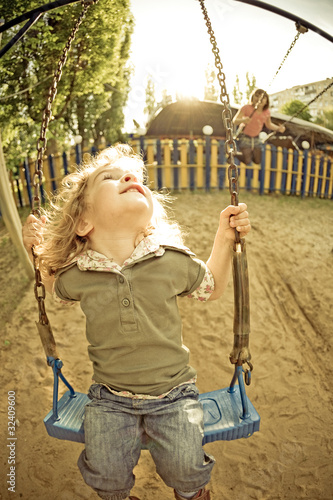 Photo: Child on swing in summer Child on swing in summer