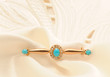 Golden brooch with turquoise and pearls on silk