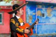 Charro Mariachi playing guitar Mexico houses Charro Mariachi playing guitar Mexico houses