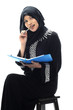 Beautiful muslim women bit a pen while thinking