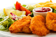 Fried chicken nuggets, French fries and vegetables