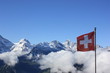 Switzerland flag against the backdrop of the Swiss mountains